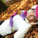woman laying on autumn ground and leaves